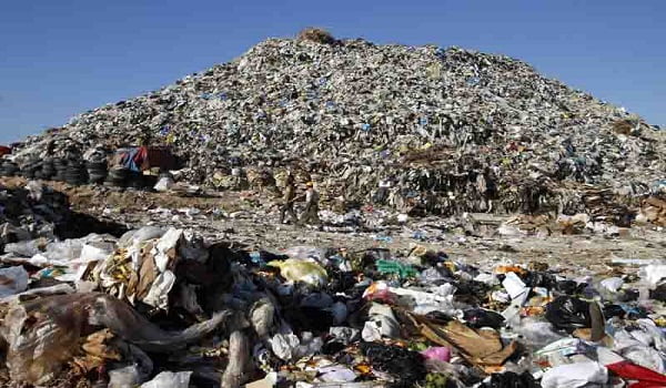 TO GO WITH AFP STORY BY RANA MOUSSAOUI: TO GO WITH AFP STORY BY RANA MOUSSAOUI: Men walk past a huge mound of garbage, piled up along the southern coastal Lebanese city of Sidon on February 06, 2008. "Sidon's mountain" bears no resemblance to the green mountains of Lebanon. It is rather an immense landfill that dumps its trash into the Mediterranean, polluting the coast of the ancient Phoenician port city. The dump is just a few metres (yards) away from the tourist sites of the southern city of Sidon -- its crusader sea castle, ancient vaulted souk and Phoenician temple. AFP PHOTO/RAMZI HAIDAR (Photo credit should read RAMZI HAIDAR/AFP/Getty Images)